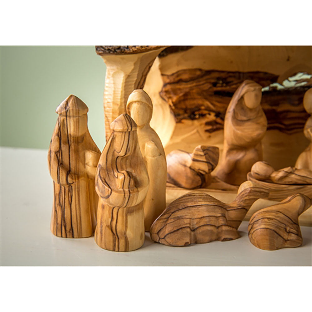 Hand-carved olive wood Nativity set with detailed figures, wood grain visible.