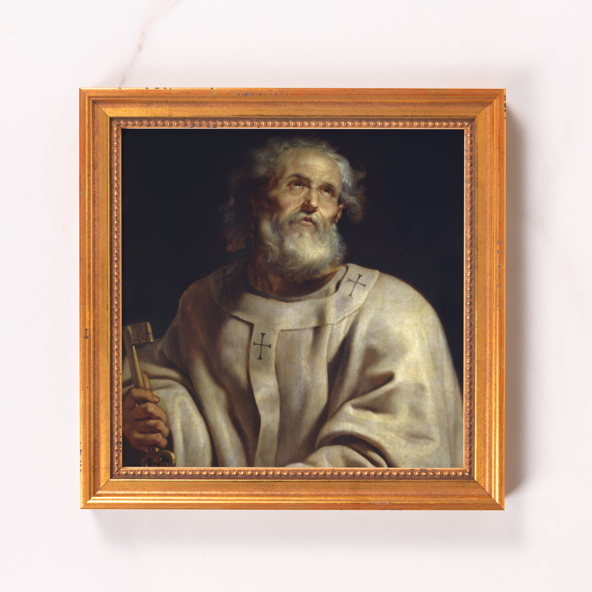 Framed painting of Saint Peter holding a key, in gold frame.