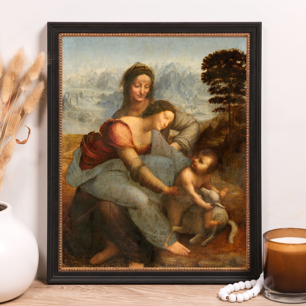 Framed artwork featuring Leonardo da Vinci's "Virgin and Child with Saint Anne" in a black frame for home decor.
