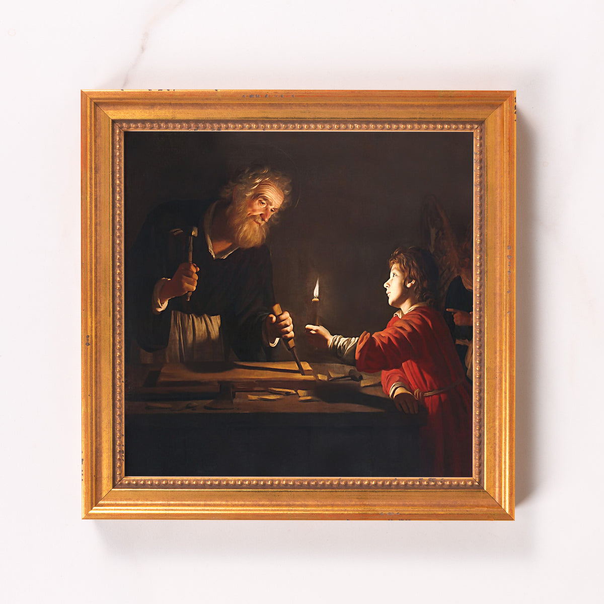 Framed painting depicts Saint Joseph at work with Jesus, oil on canvas in a golden frame.