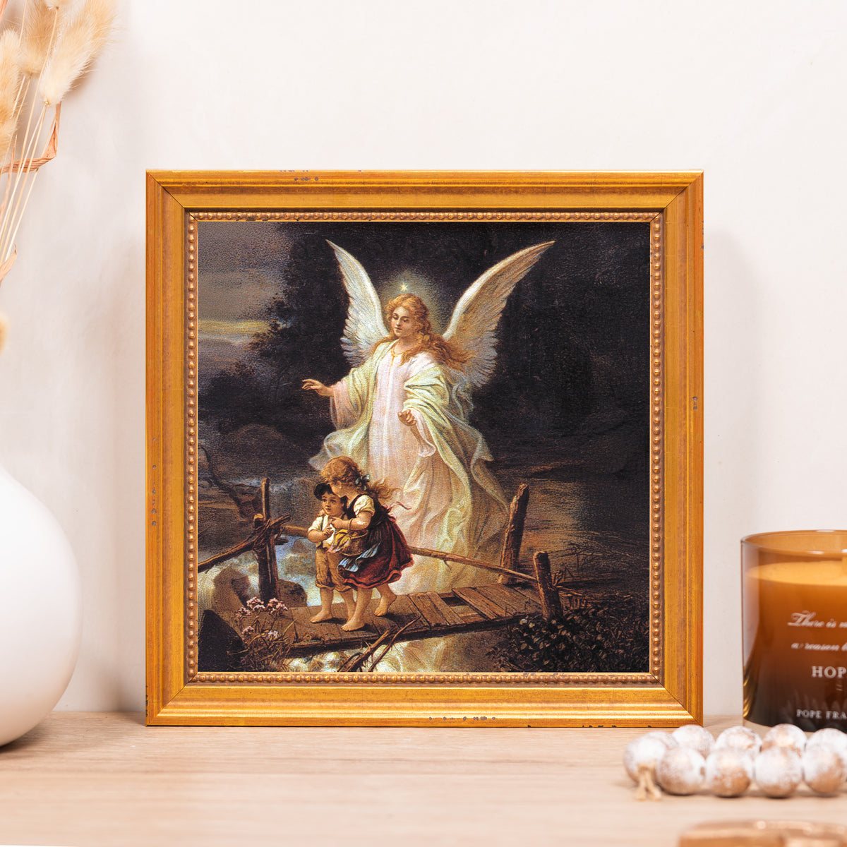 Framed print of an angel guiding two children on a bridge with a golden frame.