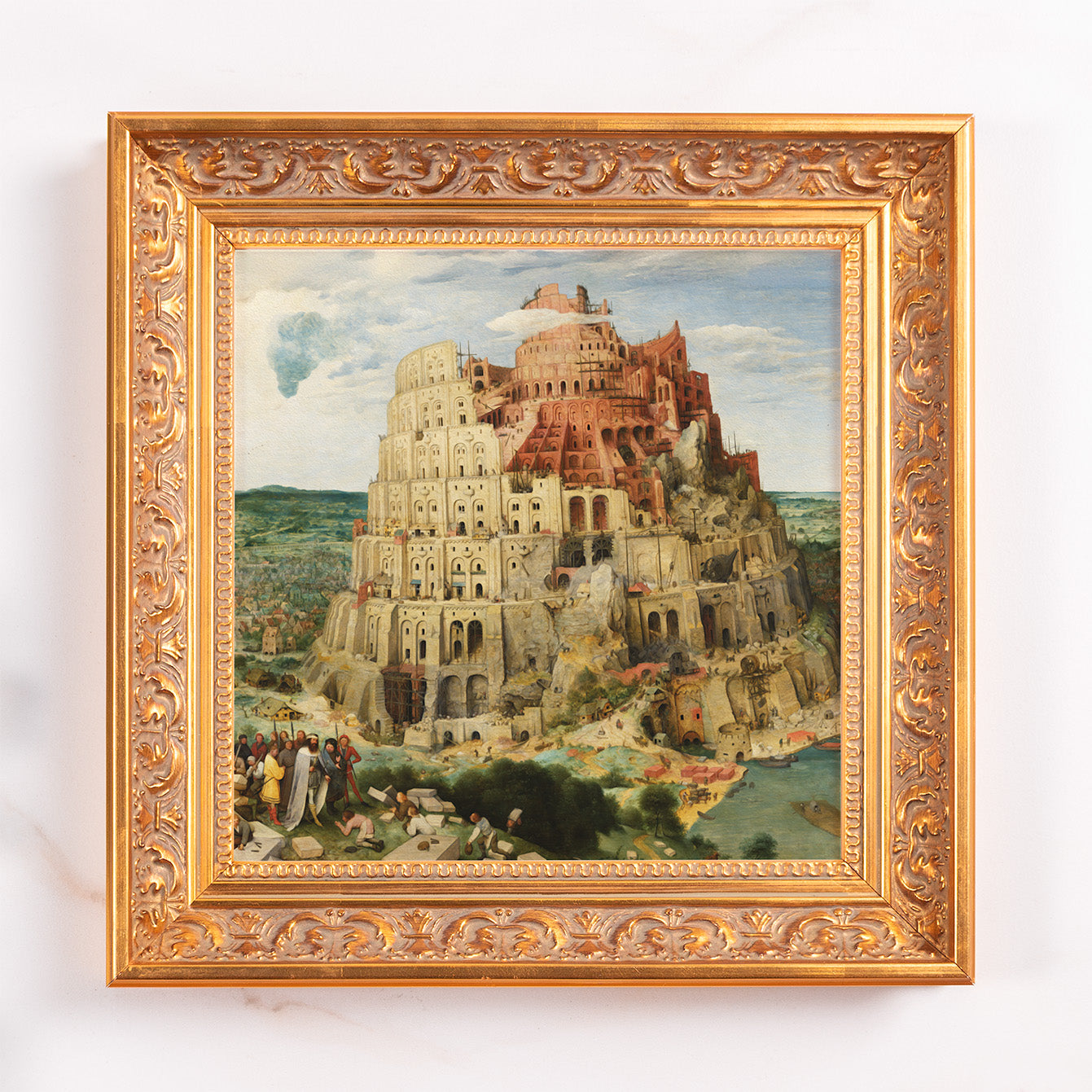 Framed Tower of Babel print; painting with a gold, decorative wooden frame.
