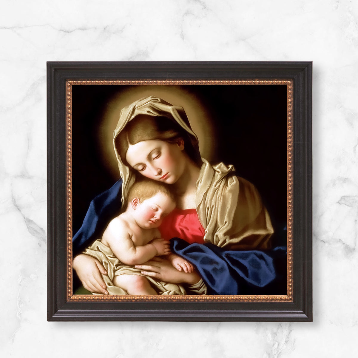Framed reproduction of Virgin Mary and baby Jesus in painted style with gold trim and dark wood frame.