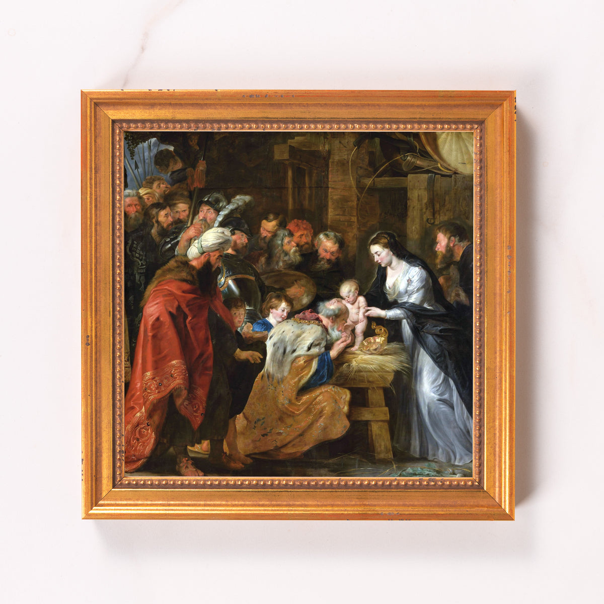 Framed oil painting depicting the Adoration of the Magi in a golden frame.