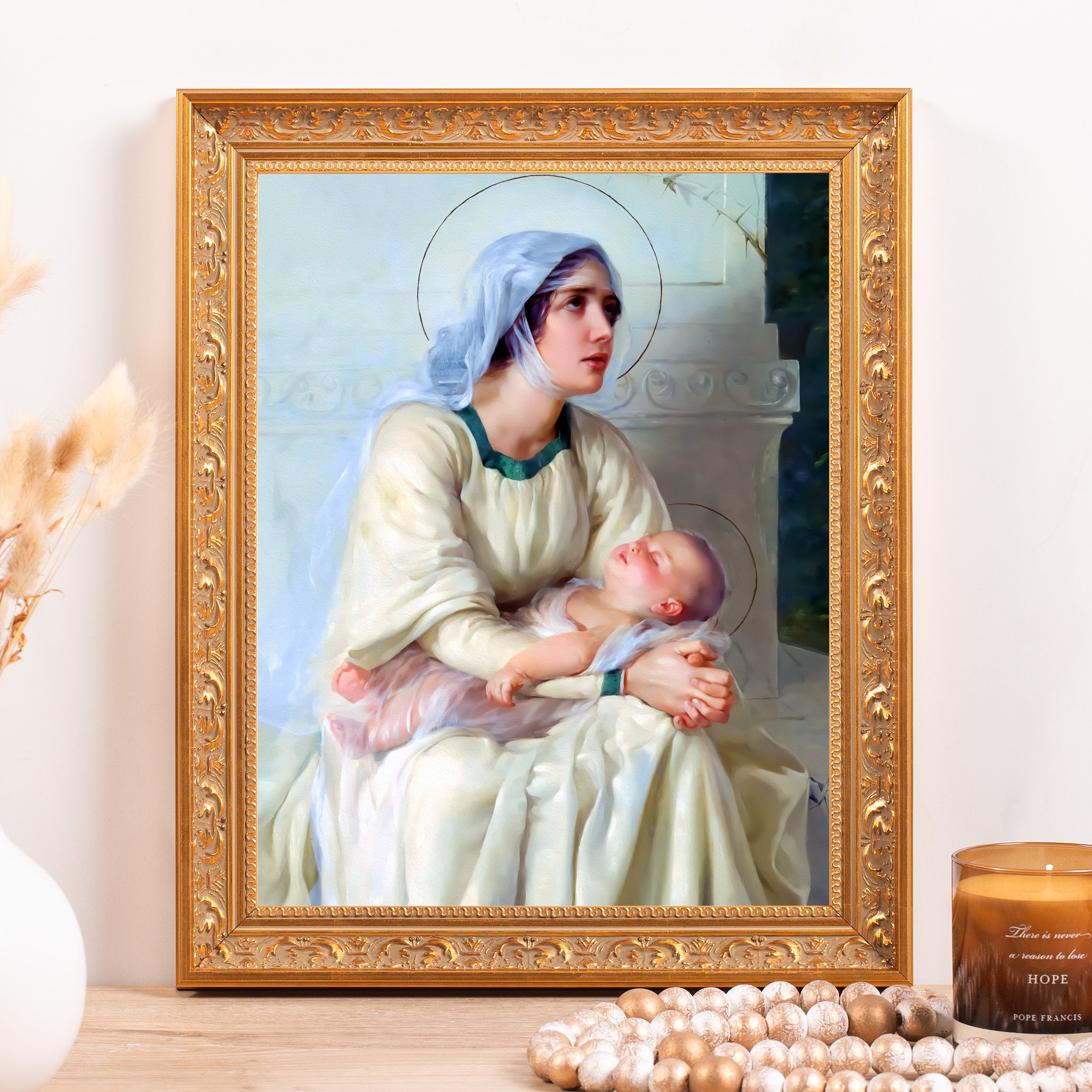 Framed religious art depicting Mary and baby Jesus with a gold ornate frame.