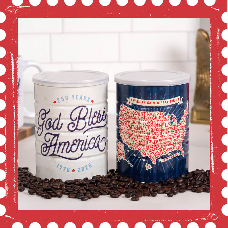 Two tin coffee containers with 'God Bless America' and map design on a surface with coffee beans.