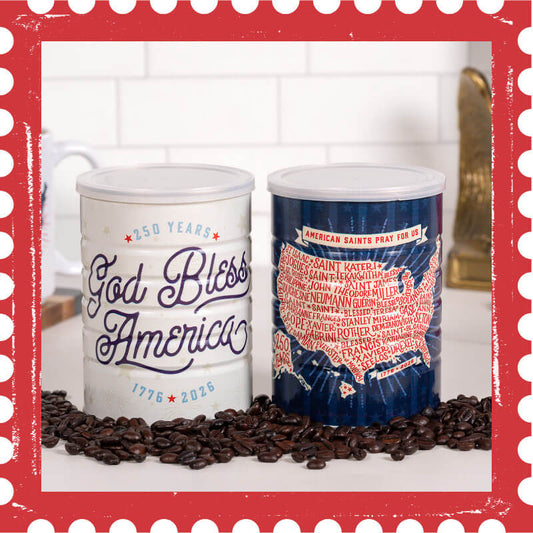 Two tin coffee containers with 'God Bless America' and map design on a surface with coffee beans.