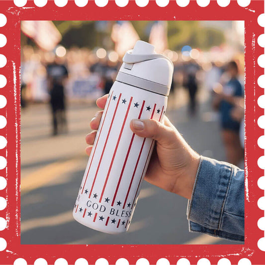 Hand holding a water bottle with stars and stripes and God Bless America on it.