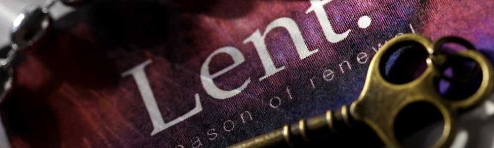 Close-up image of an antique key resting on a fabric with the word "Lent" and "A season of renewal" printed in white on a purple and red background.