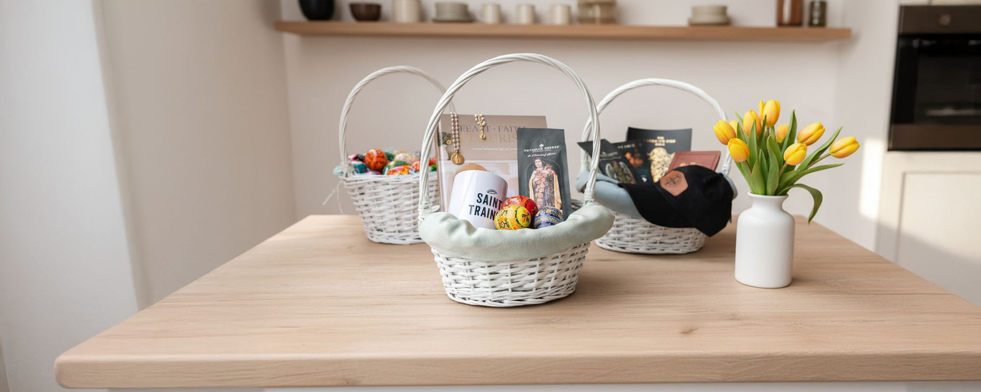Three Easter baskets with eggs and gifts on a wooden table beside yellow tulips.
