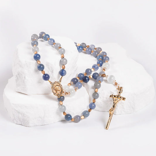 Rosary with blue and gray beads on a white background