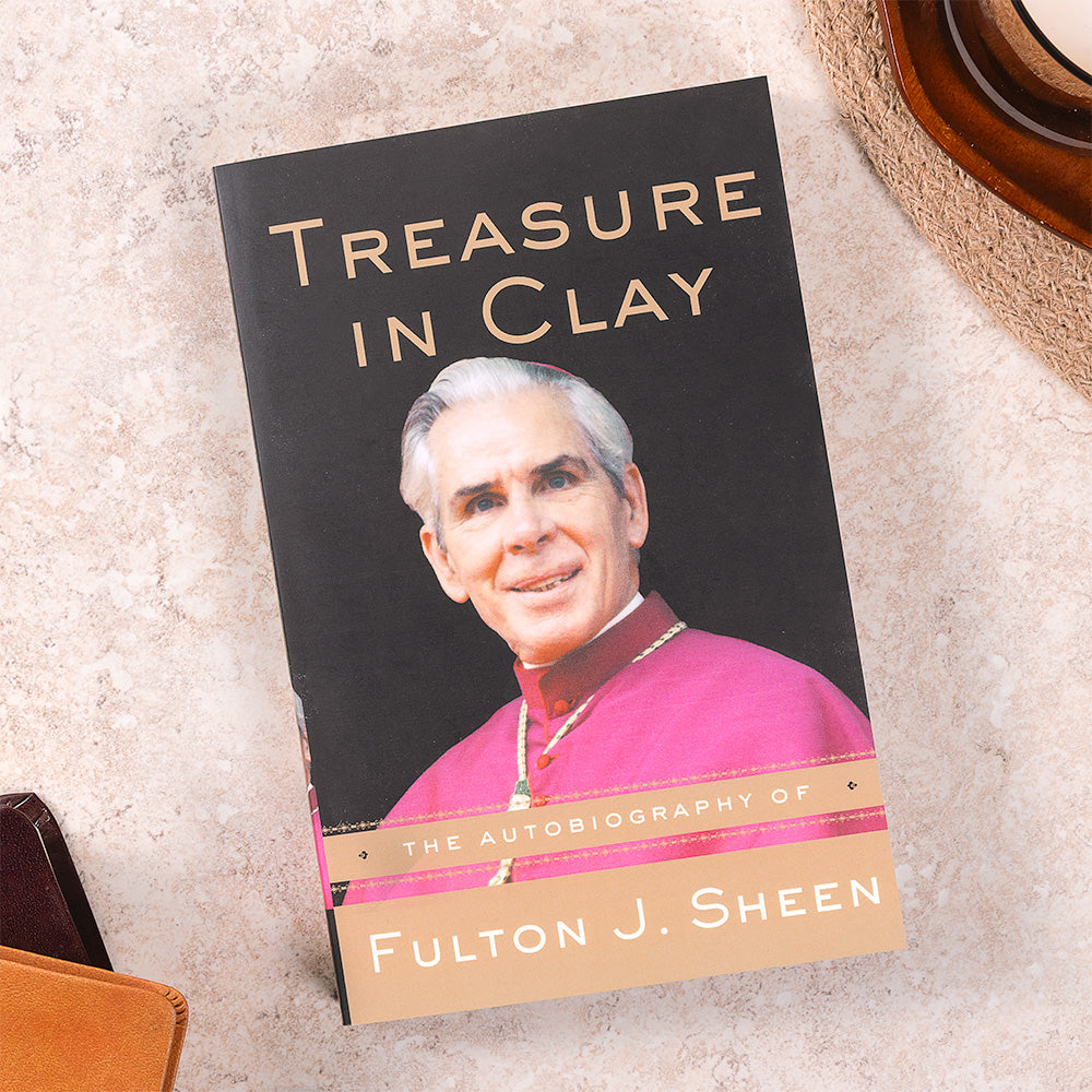 Book titled 'Treasure in Clay' with a Fulton Sheen on the cover, placed on a textured surface.