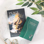 Two books titled 'Peace Be With You' and 'Healing Prayers for Every Day' on a marble surface with green leaves.