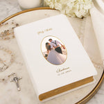 Personalized Bible with wedding photo and text on a marble surface.
