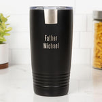 Black insulated tumbler with 'Father Michael' engraving on a white surface.