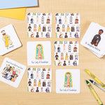 Educational cards with illustrated figures on a wooden surface with markers.