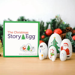 Decorative eggs with Christmas-themed illustrations in front of a 'The Christmas Story Egg' book
