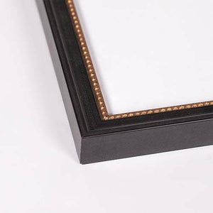 Close-up of a black picture frame corner with a decorative gold beaded inner border, shown on a plain white background.