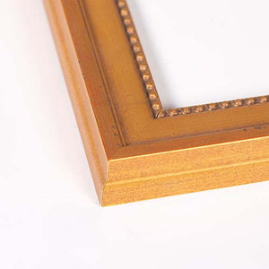 Close-up of a gold picture frame corner with a beaded inner border, shown on a plain white background.