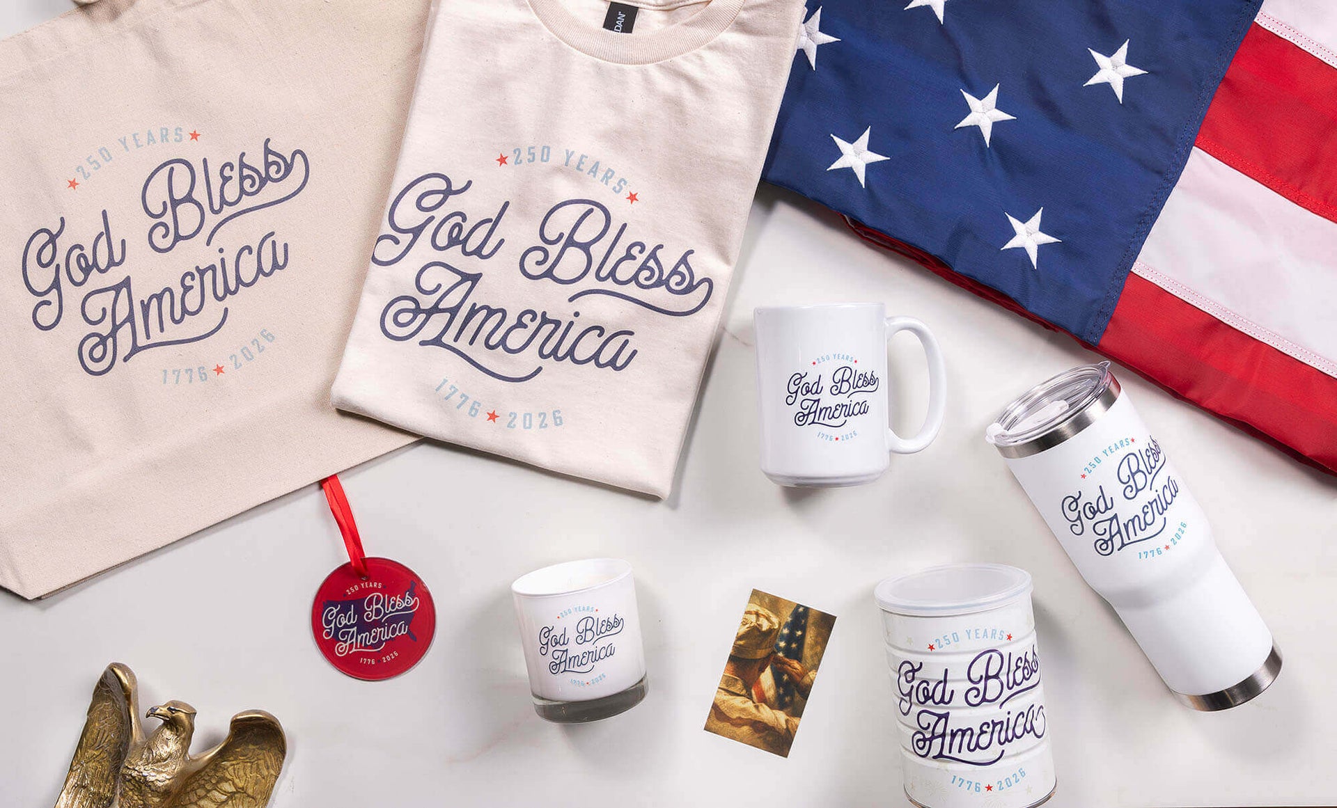 Collection of 'God Bless America' merchandise including mugs, t-shirts, and a flag on a white background.