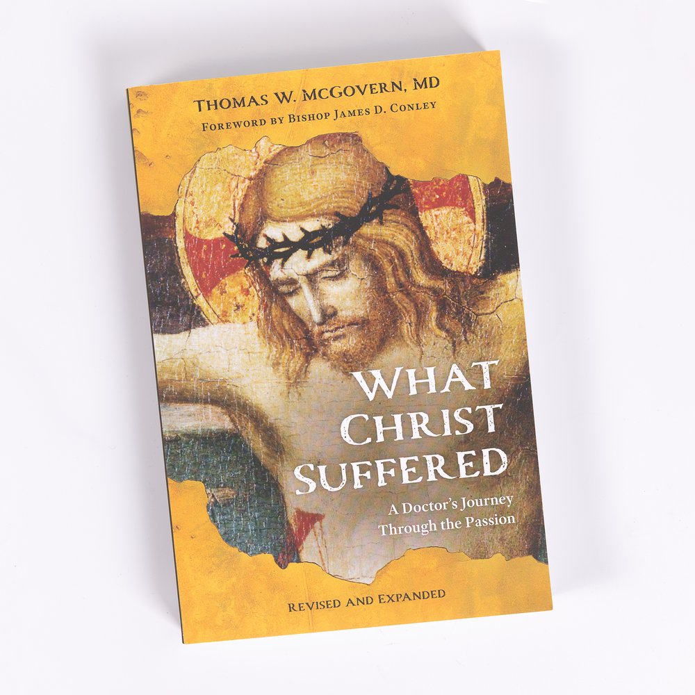 Book, "What Christ Suffered," with yellow cover and art of Jesus with crown of thorns.