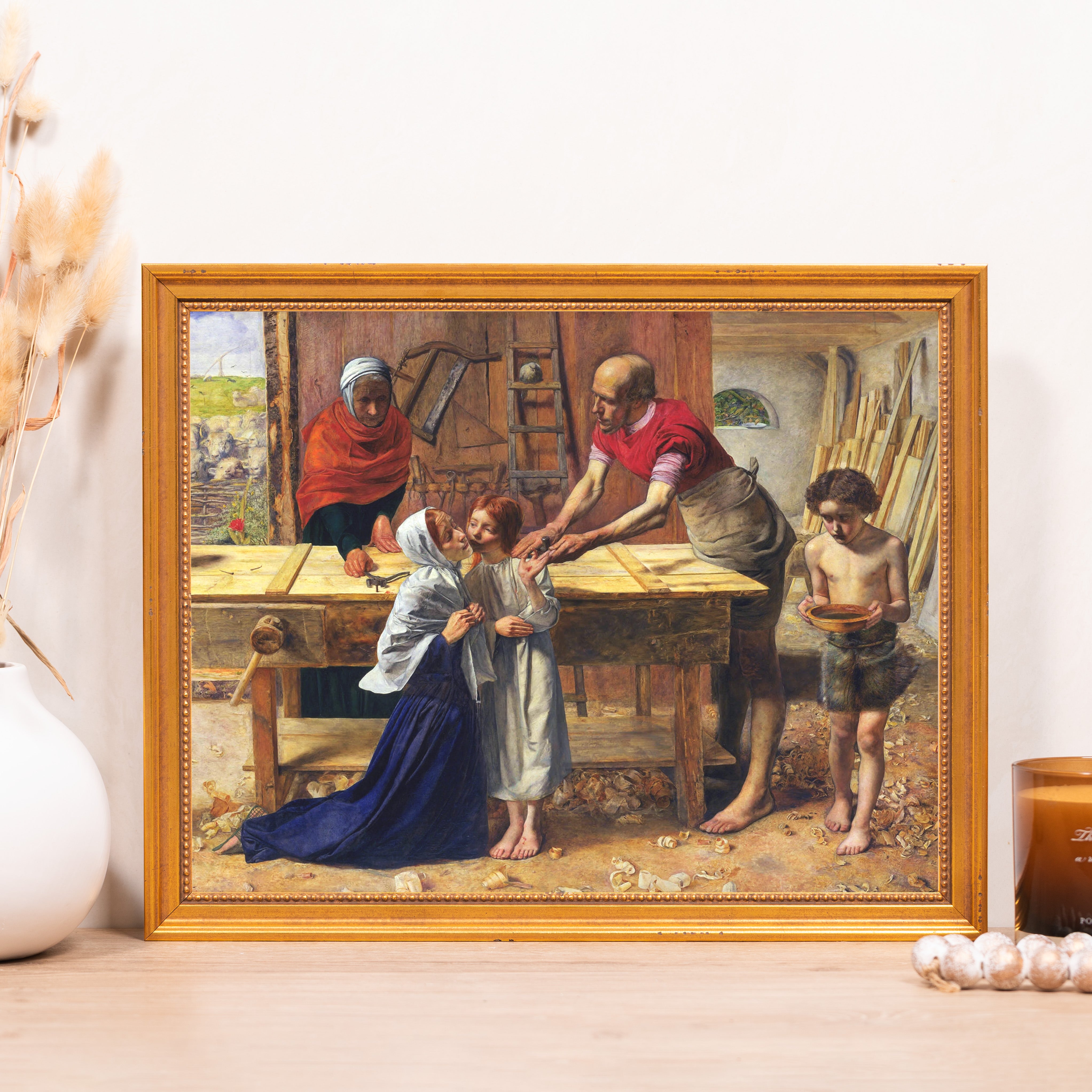 "The Carpenter's Shop" oil painting in a gold frame depicts Jesus as a boy with his family in a wood shop.