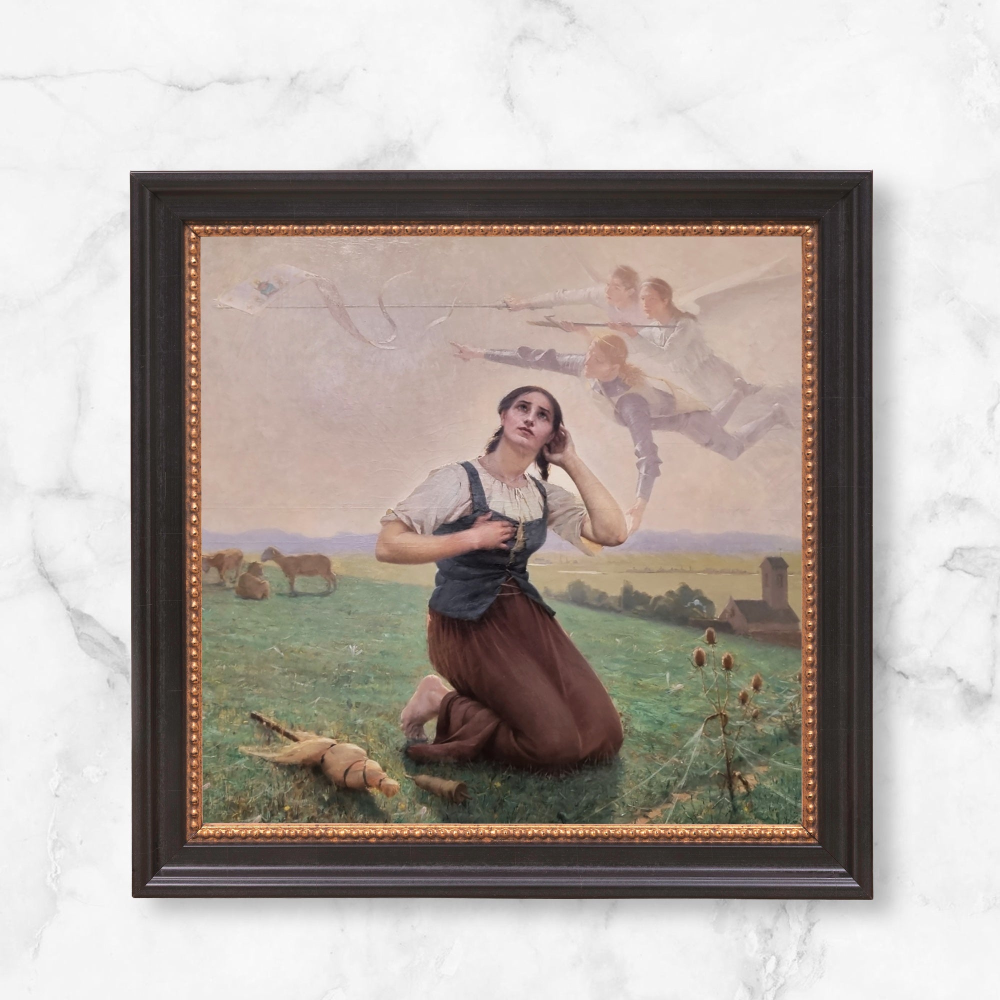 Framed oil painting print depicting Joan of Arc kneeling in a field with angels.