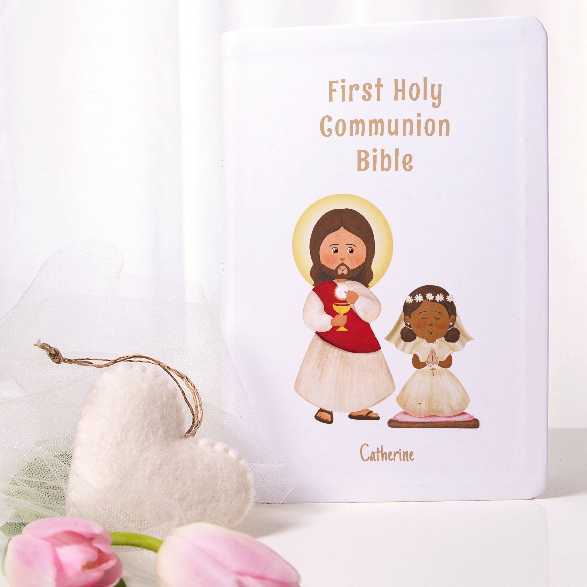 White, Hardcover First Holy Communion Bible featuring Jesus and a girl with a rosary drawing on the front cover.
