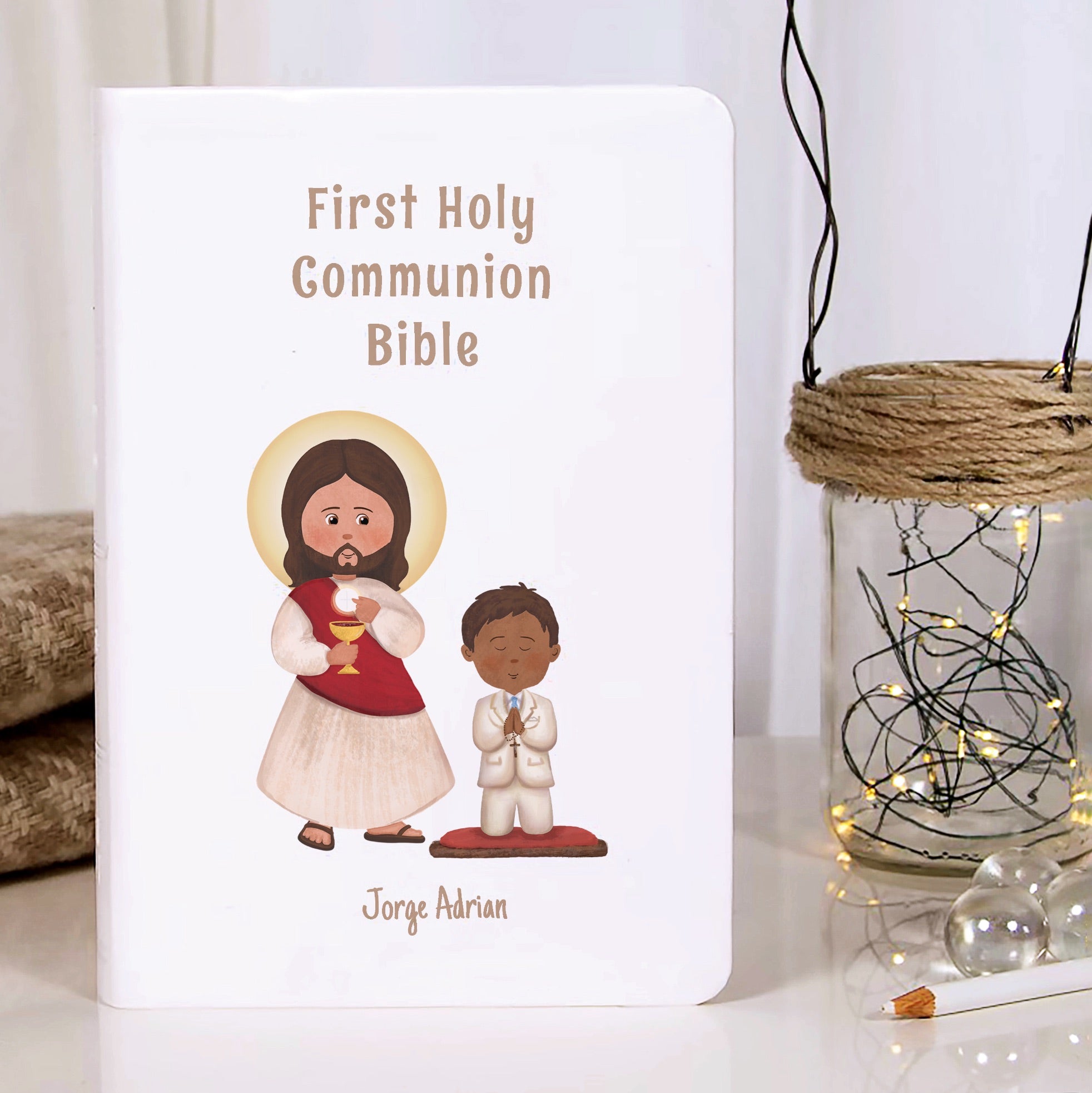 First communion Bible with cartoon illustration of Jesus and a boy on a white background.