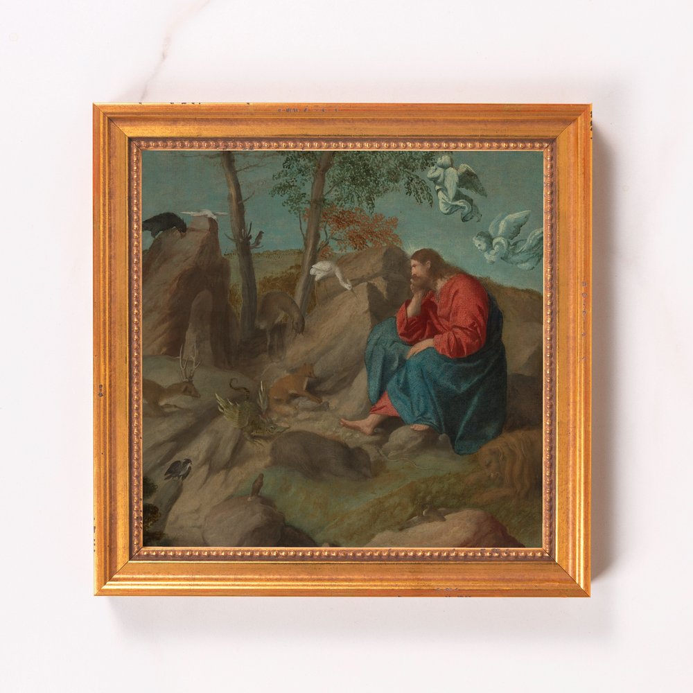 Framed painting of Jesus with animals, blue robe, gold frame.