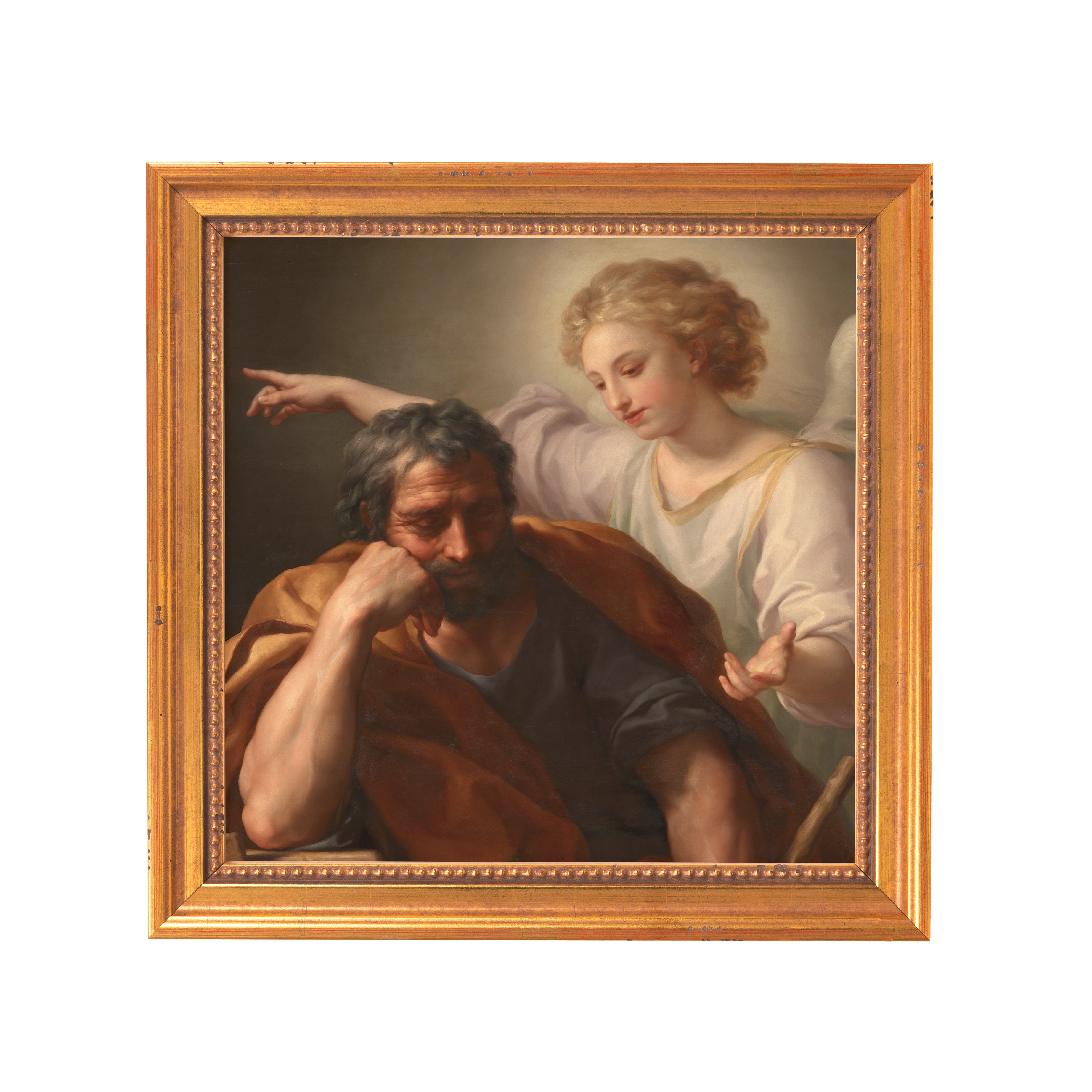 Framed oil painting of Joseph's dream, in a gold-colored frame, with the man in brown robe and an angel in white gown beside him.