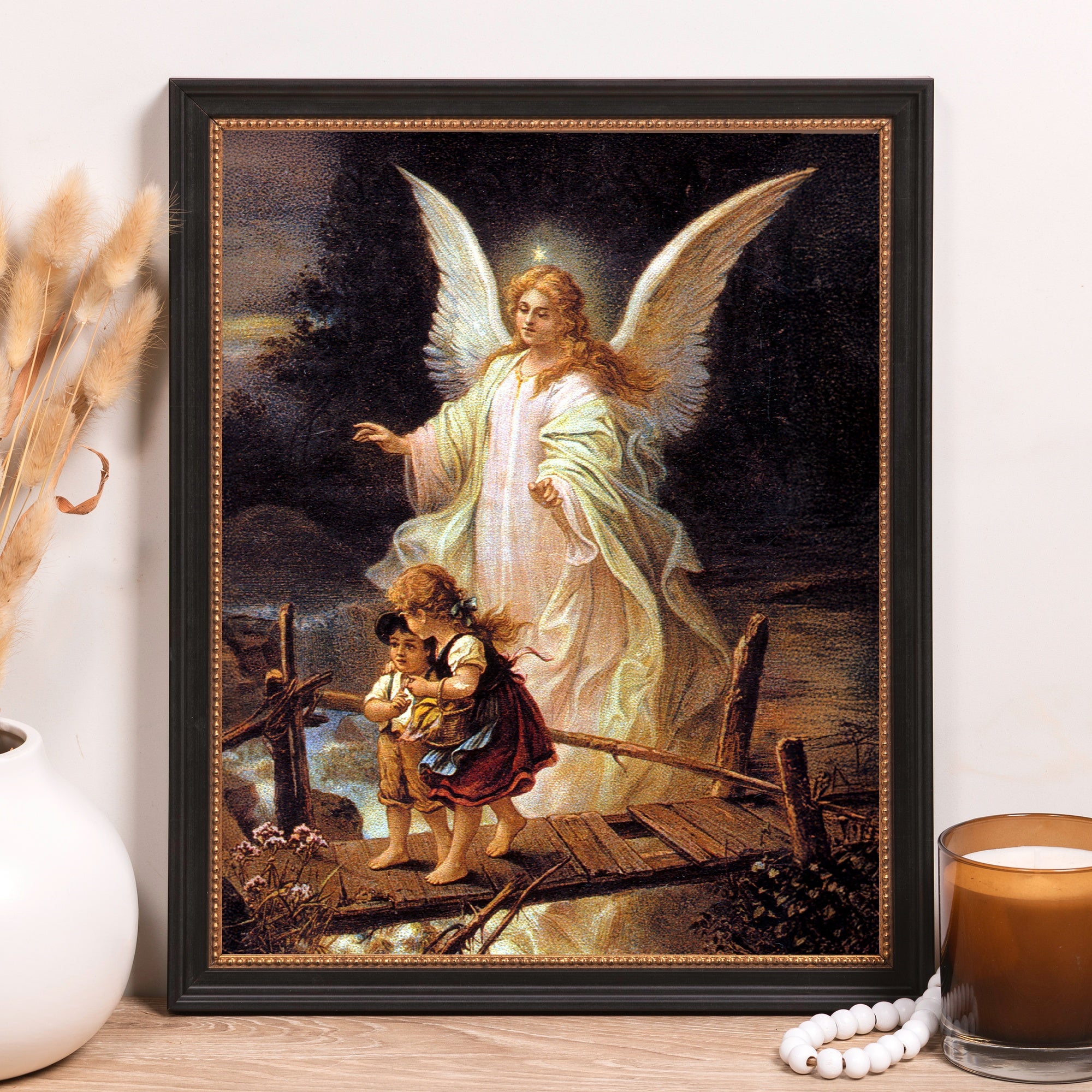 Framed "Guardian Angel" print. Features children and angel on bridge; black frame with gold accents.