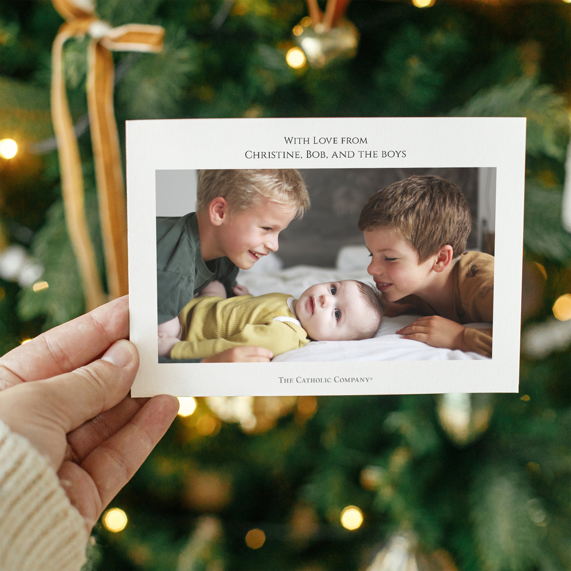 Holiday card features family photo, text, with white paper and festive background.