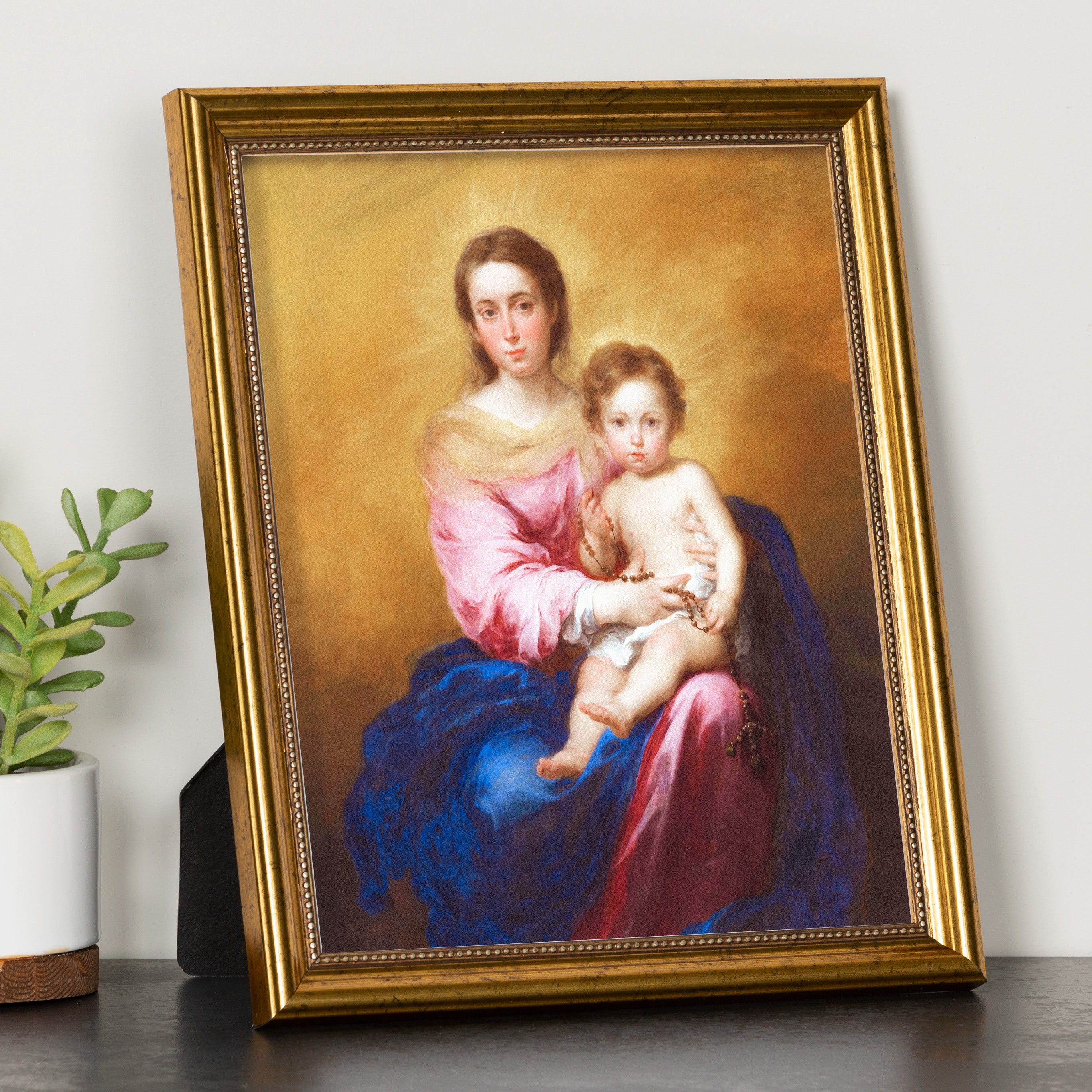 Framed print of the Virgin Mary and baby Jesus with a gold frame and gold background.