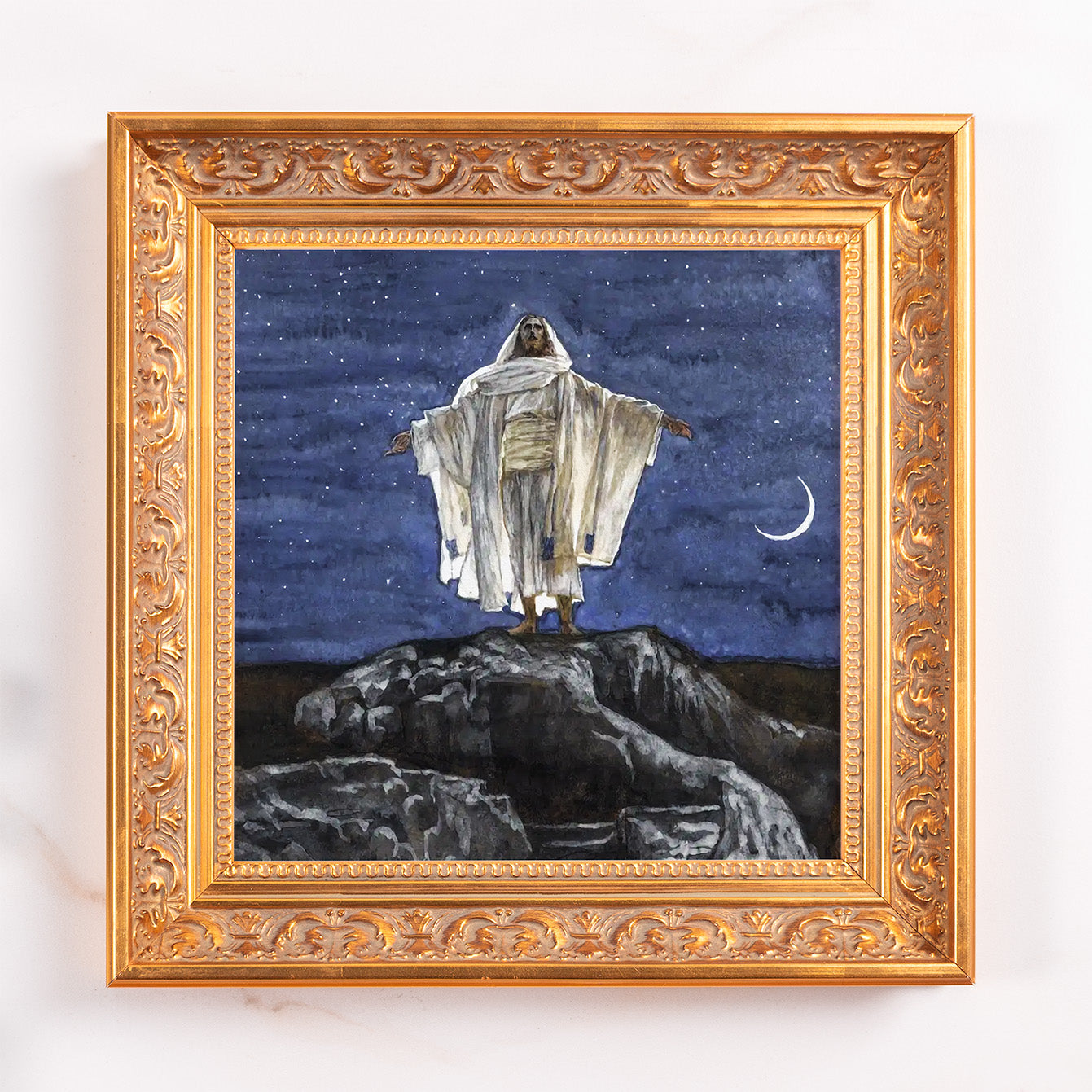 Framed painting of Jesus on a mountain in a gold-colored ornate frame.