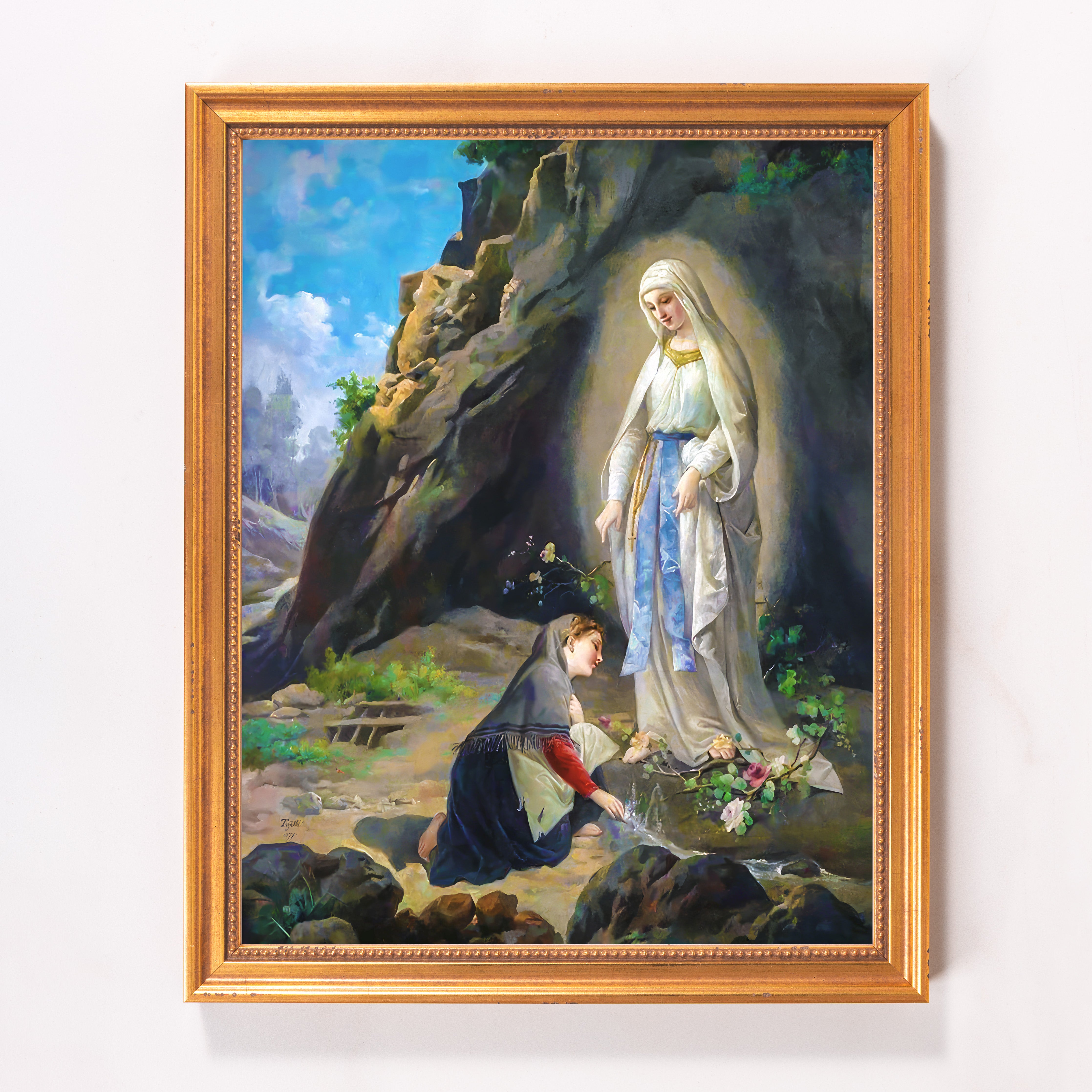 Framed painting of the Virgin Mary in a white dress and golden frame.