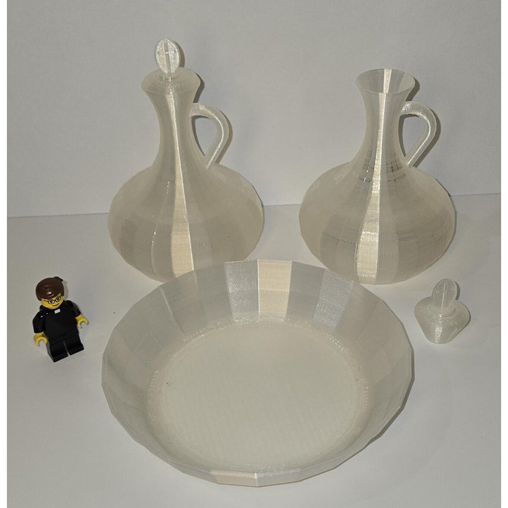 White, 3D-printed vessels and bowl with geometric design, shown with a Lego figure for scale.