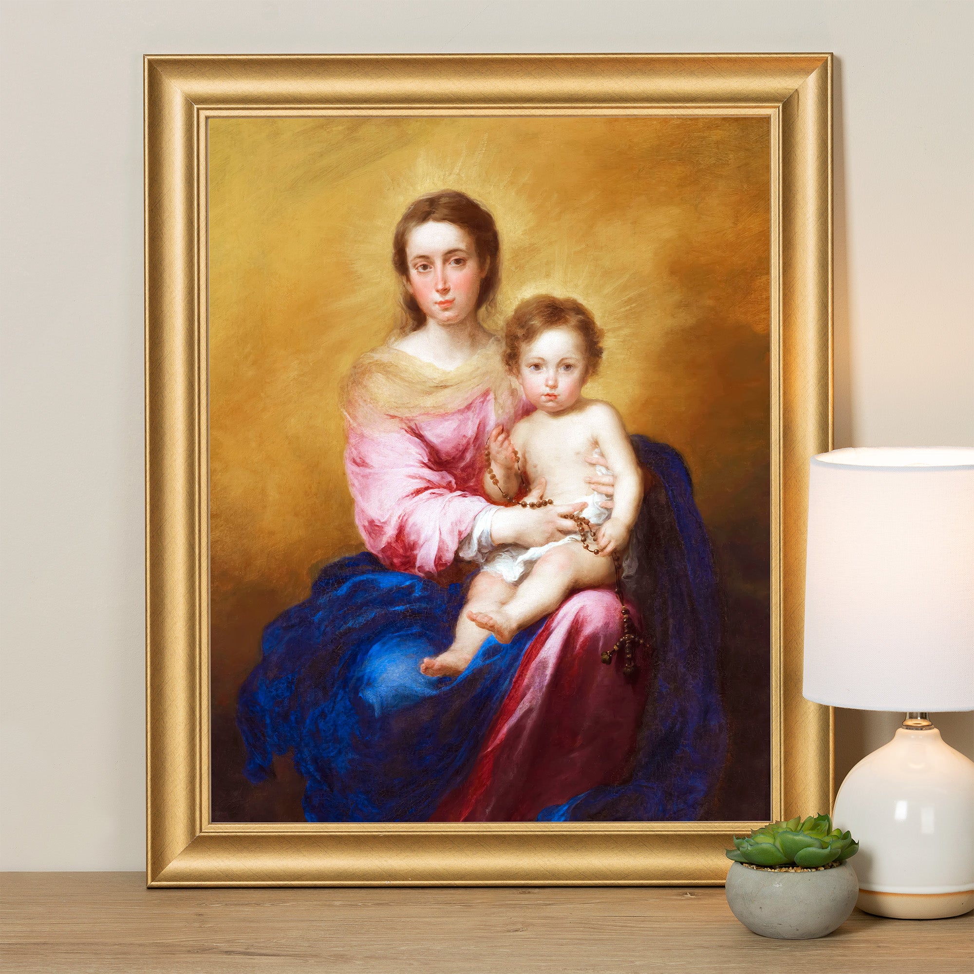 Framed portrait of Mary and Jesus, painted in a traditional style with pink, blue, and gold tones.