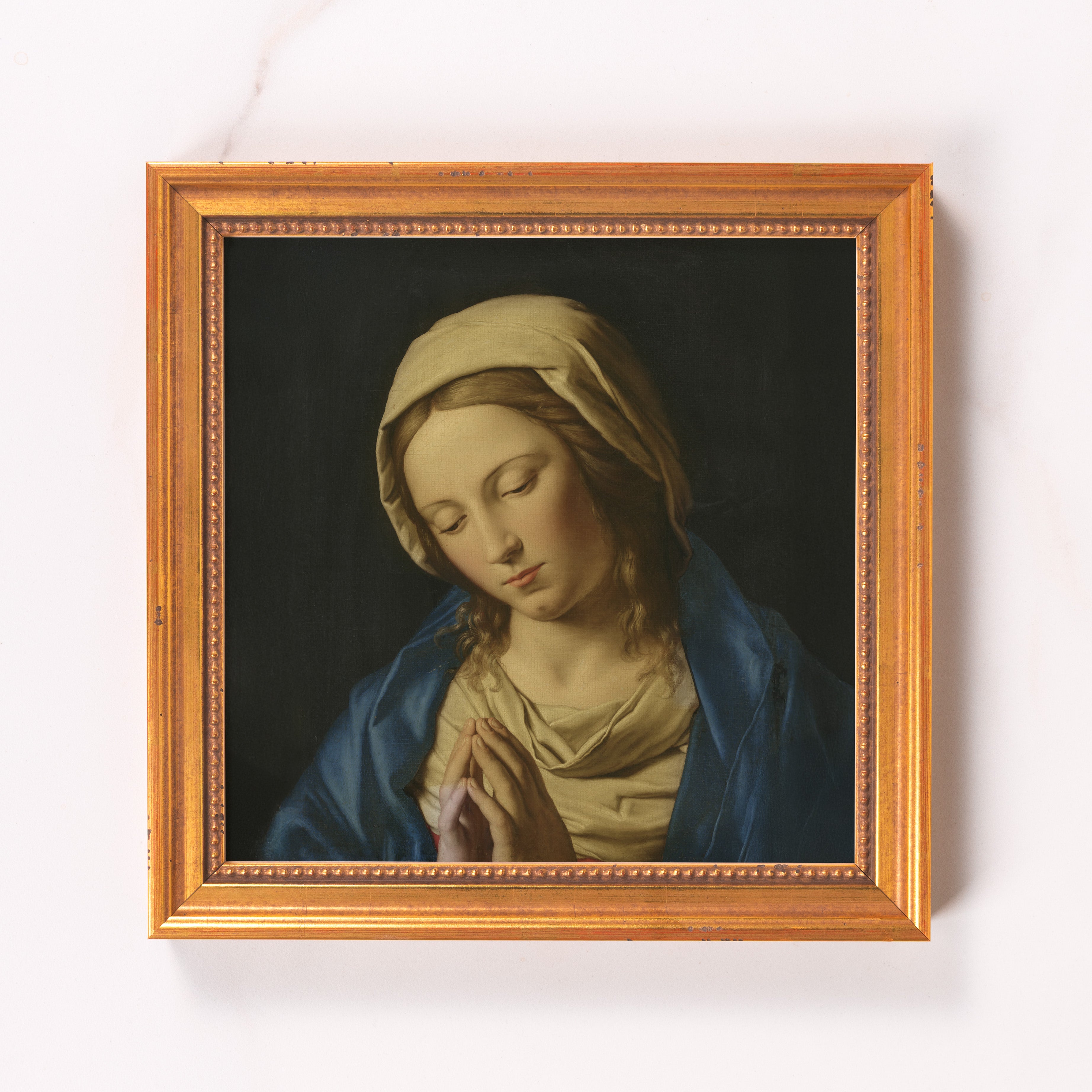 Framed painting of Mary in blue and gold with a gold frame for wall decor.