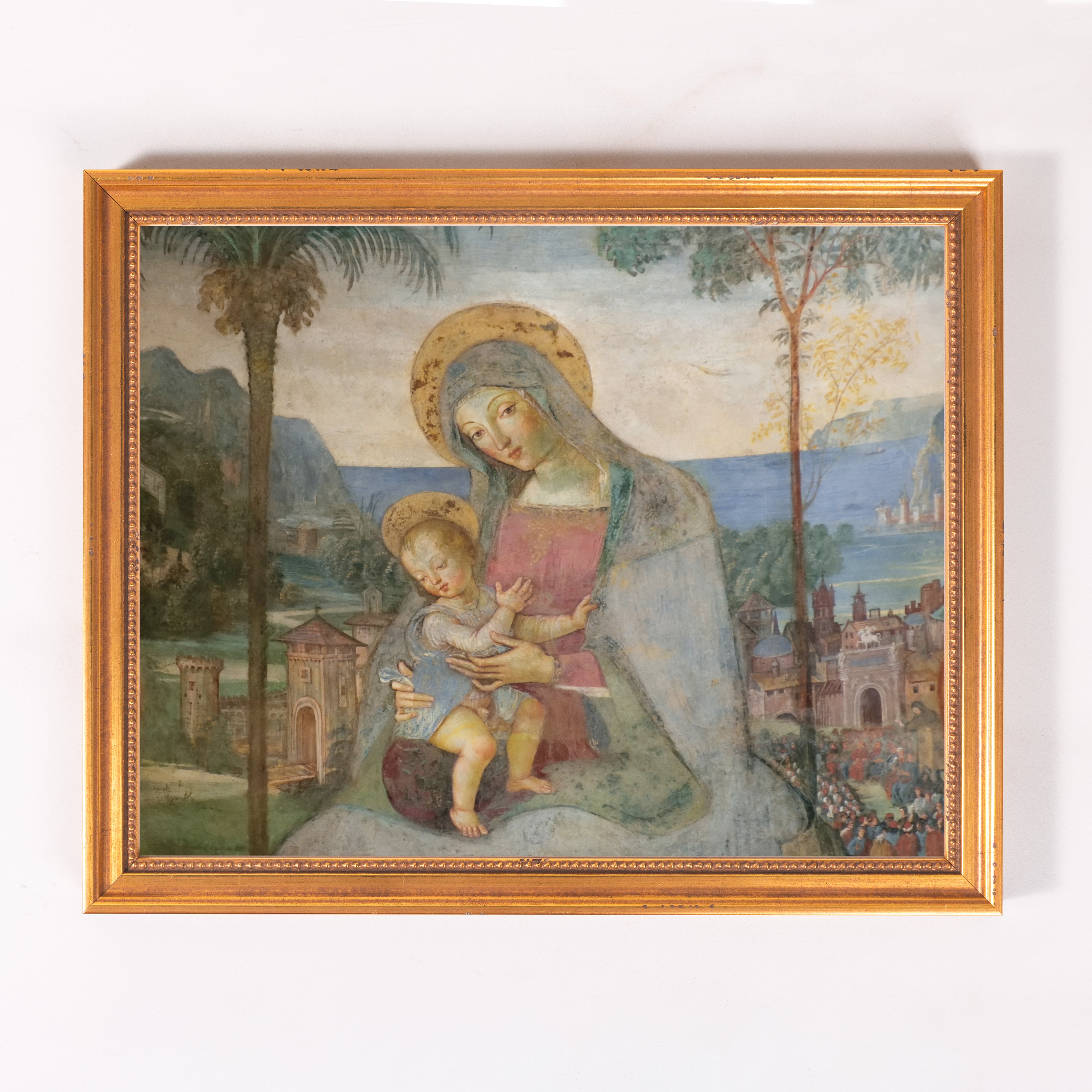 Framed, Biblical art depicting Mary holding baby Jesus, rendered with muted colors and a landscape backdrop.