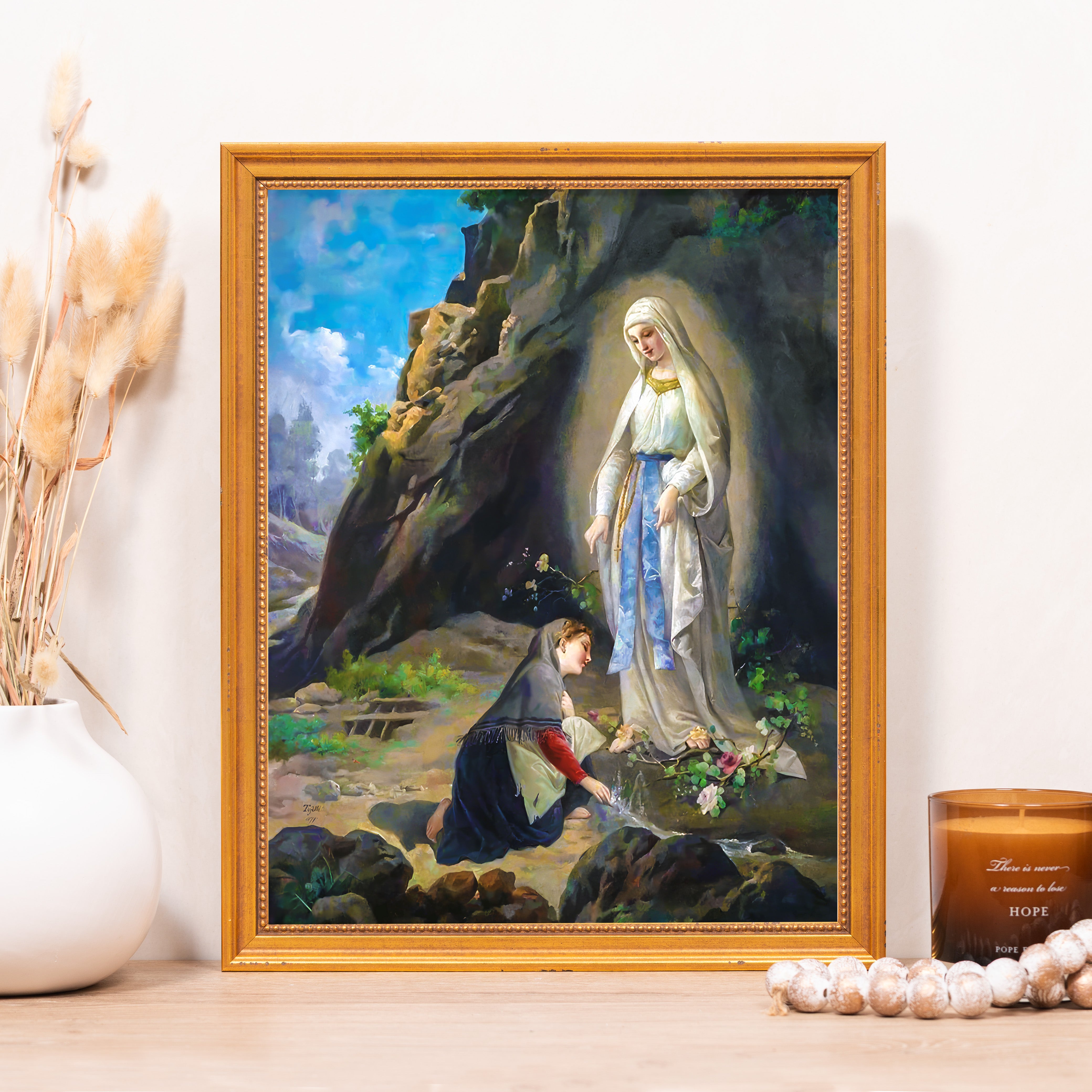 Framed print of Our Lady of Lourdes, a painting of a woman kneeling before the Virgin Mary near a rocky spring.