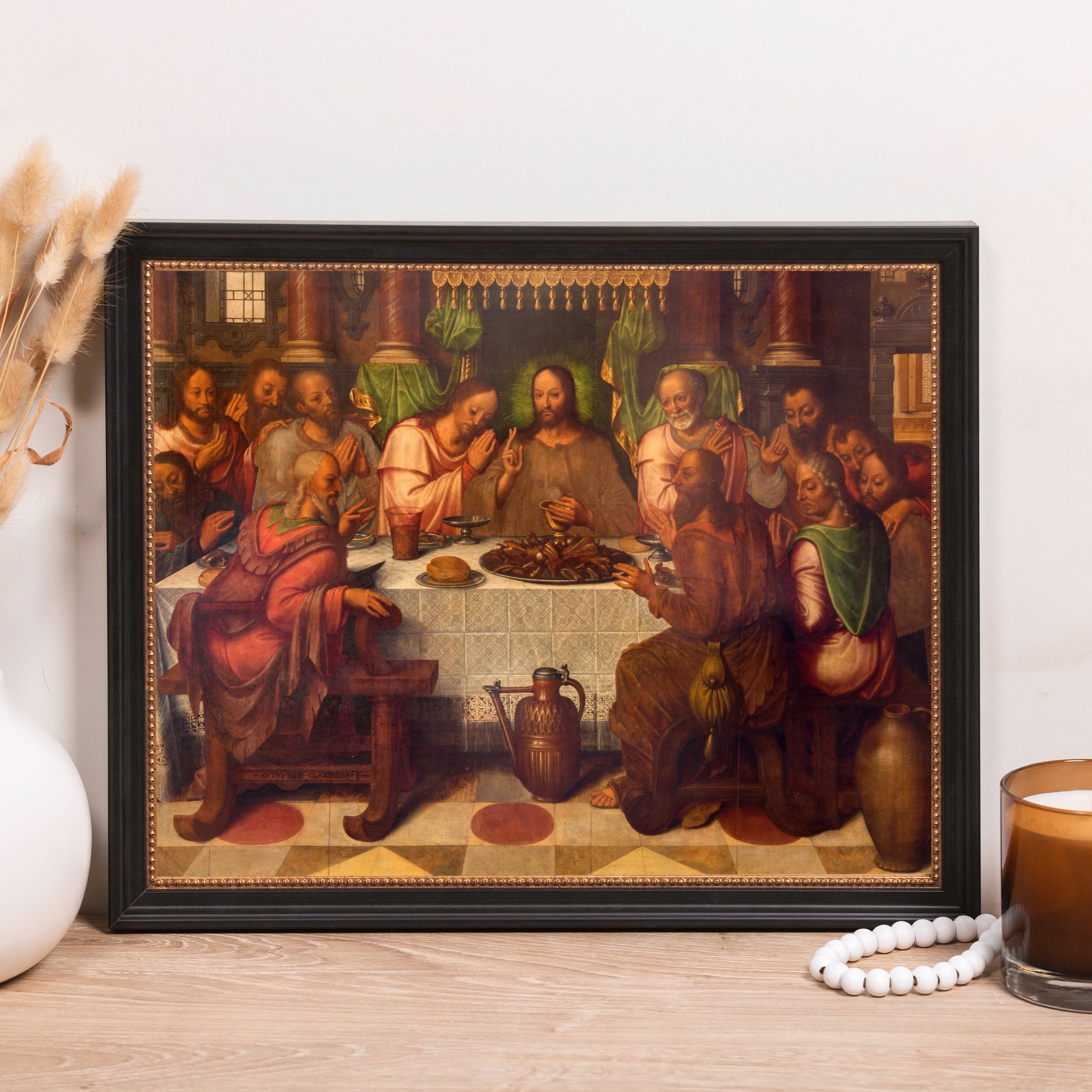 Framed reproduction of "The Last Supper," vintage painting with dark wood frame and ornate gold trim.