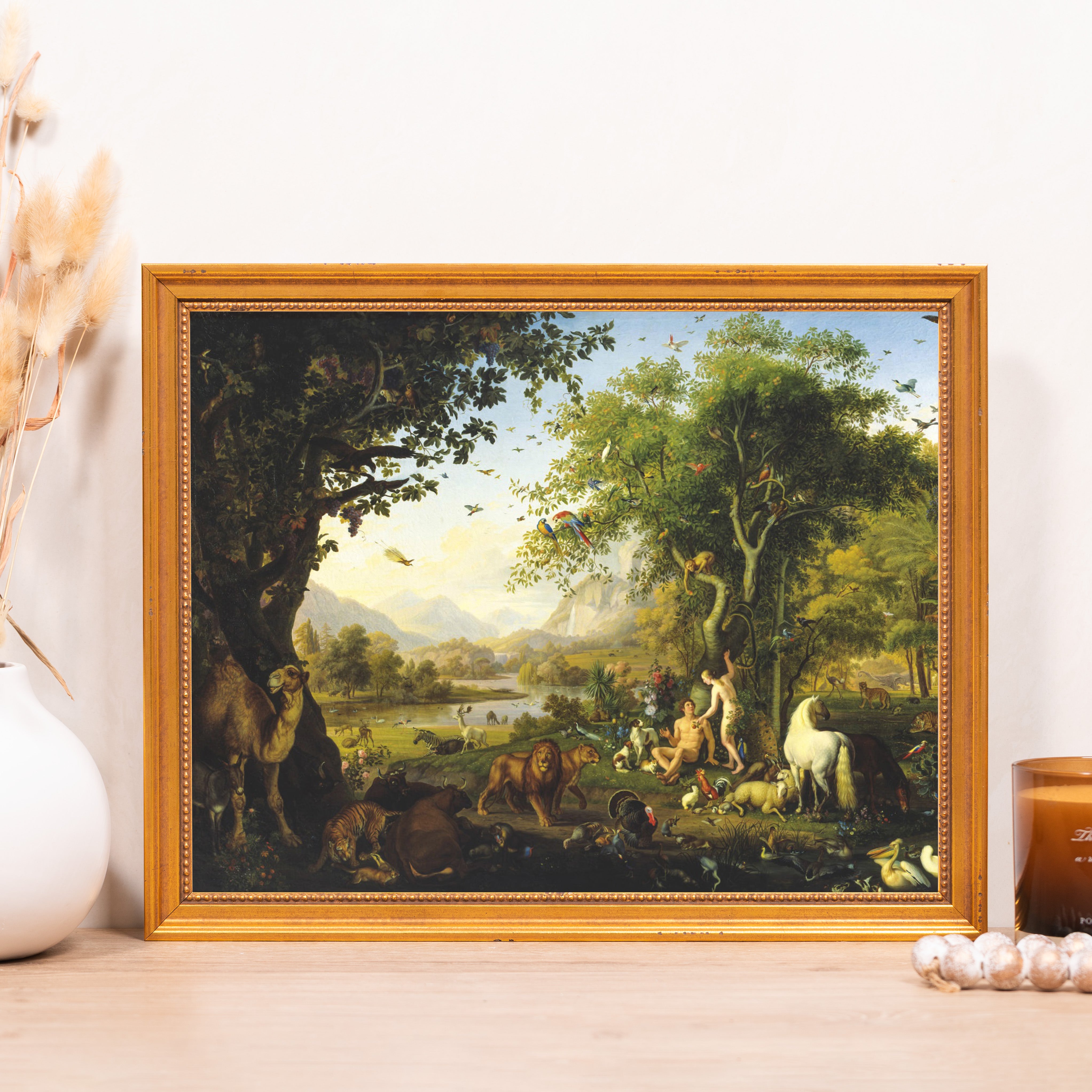 Framed, detailed oil painting of Adam and Eve with animals in Eden, gold frame.