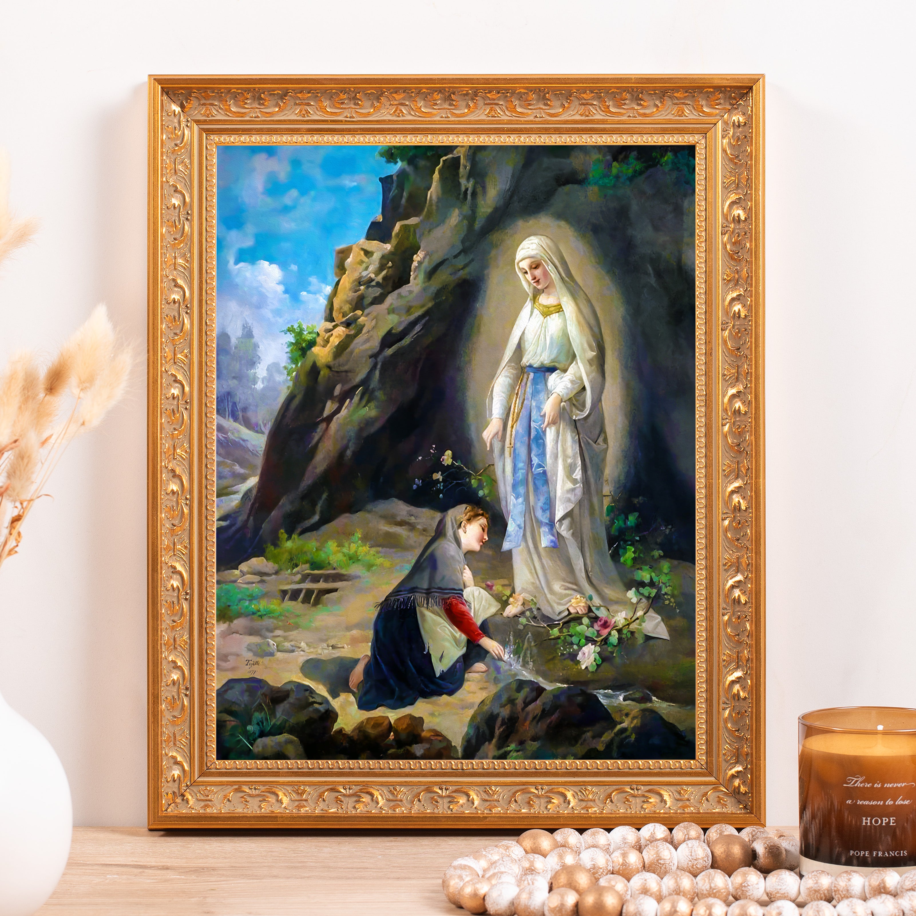 Framed painting of the Virgin Mary and Bernadette Soubirous in a gold frame.