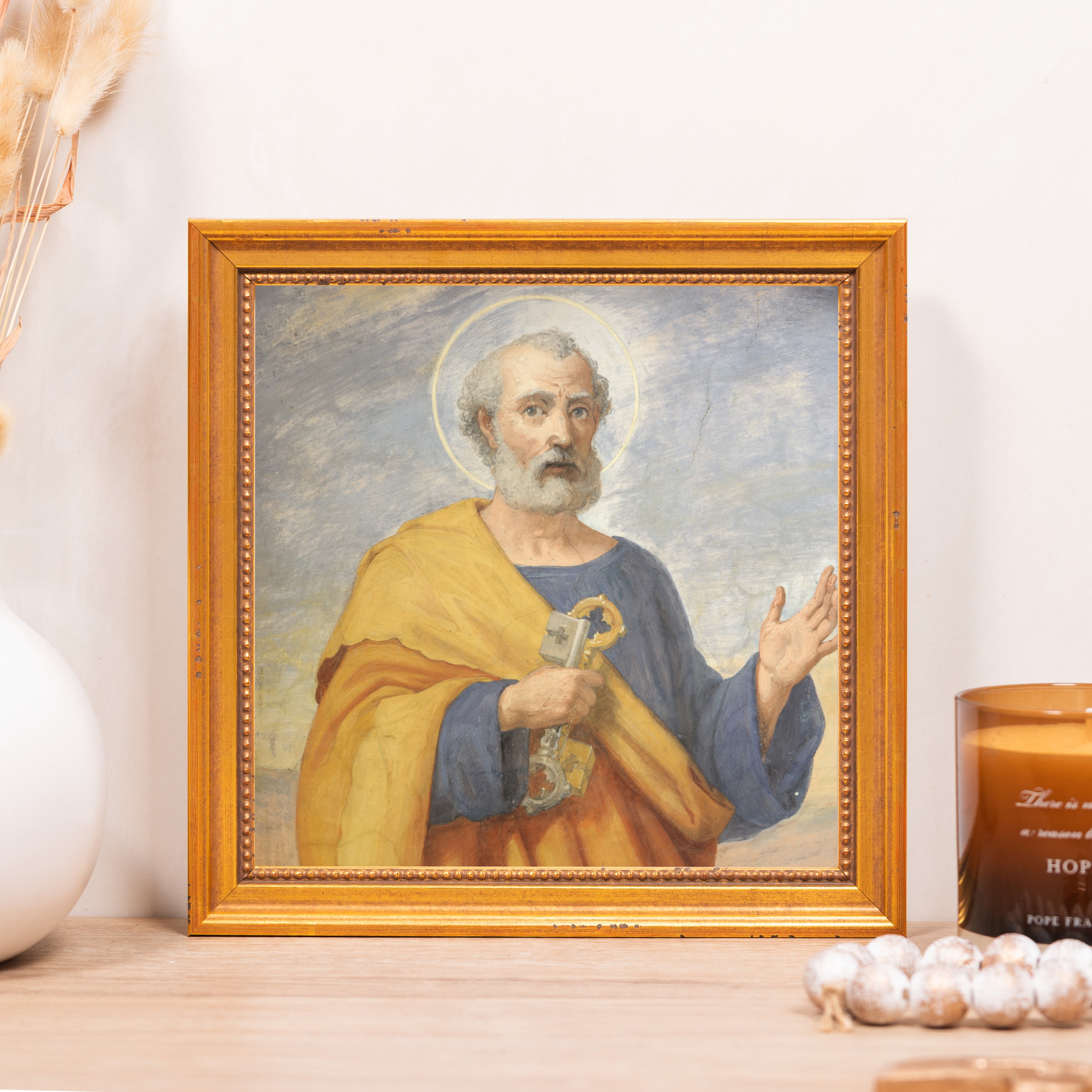 Framed portrait of Saint Peter holding keys, gold frame, yellow and blue colors.