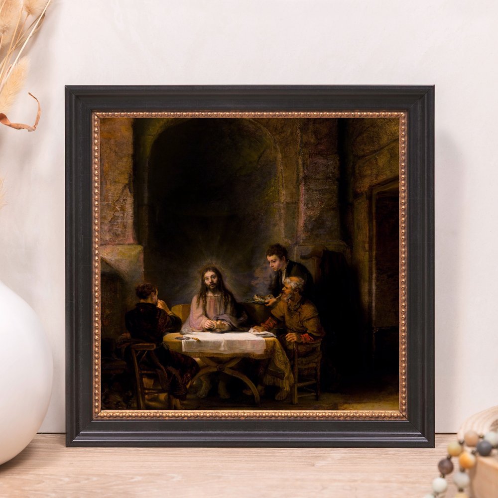 Framed painting depicts Jesus dining with disciples, in dark tones, framed in black with copper trim.