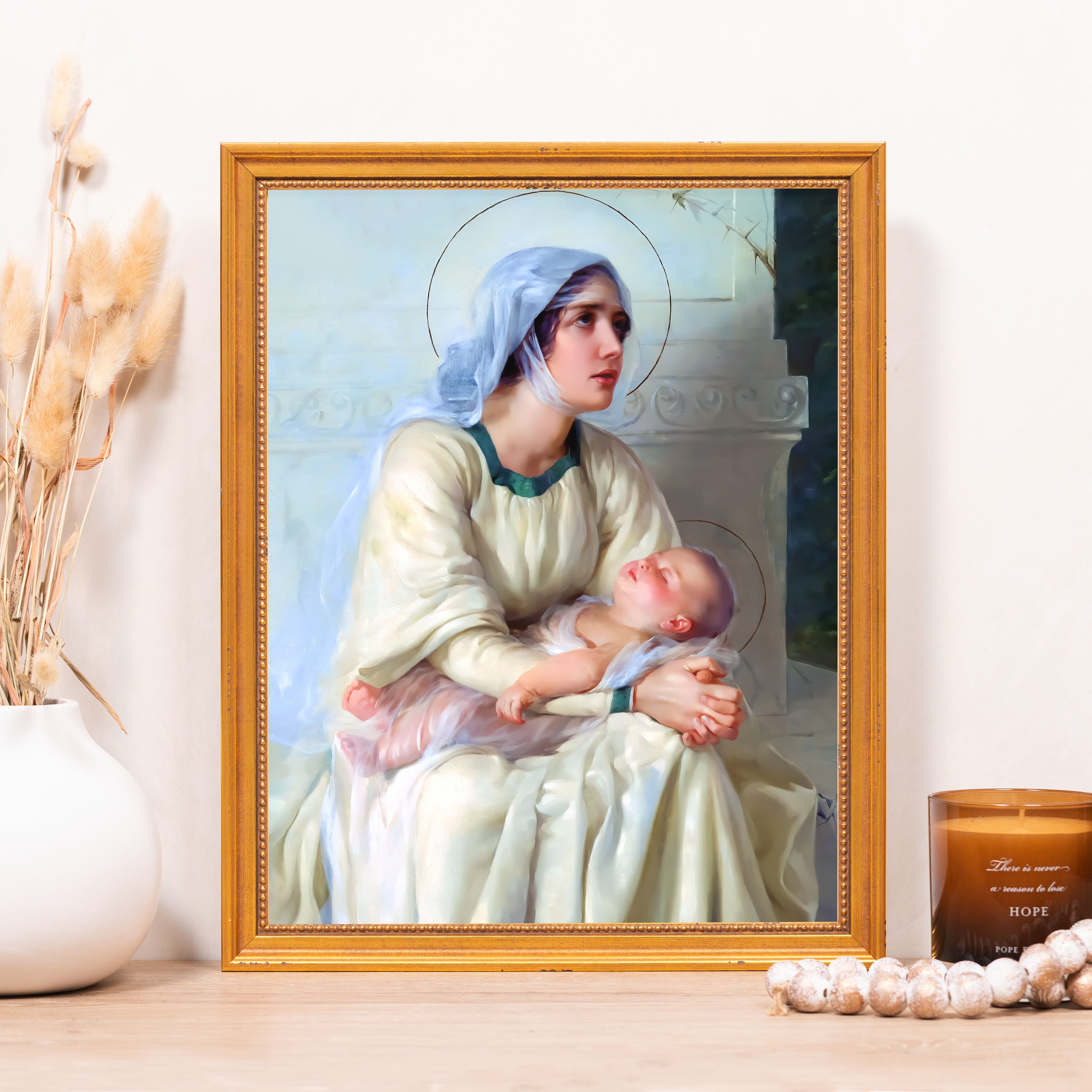 Religious painting of Mary holding baby Jesus in golden frame.