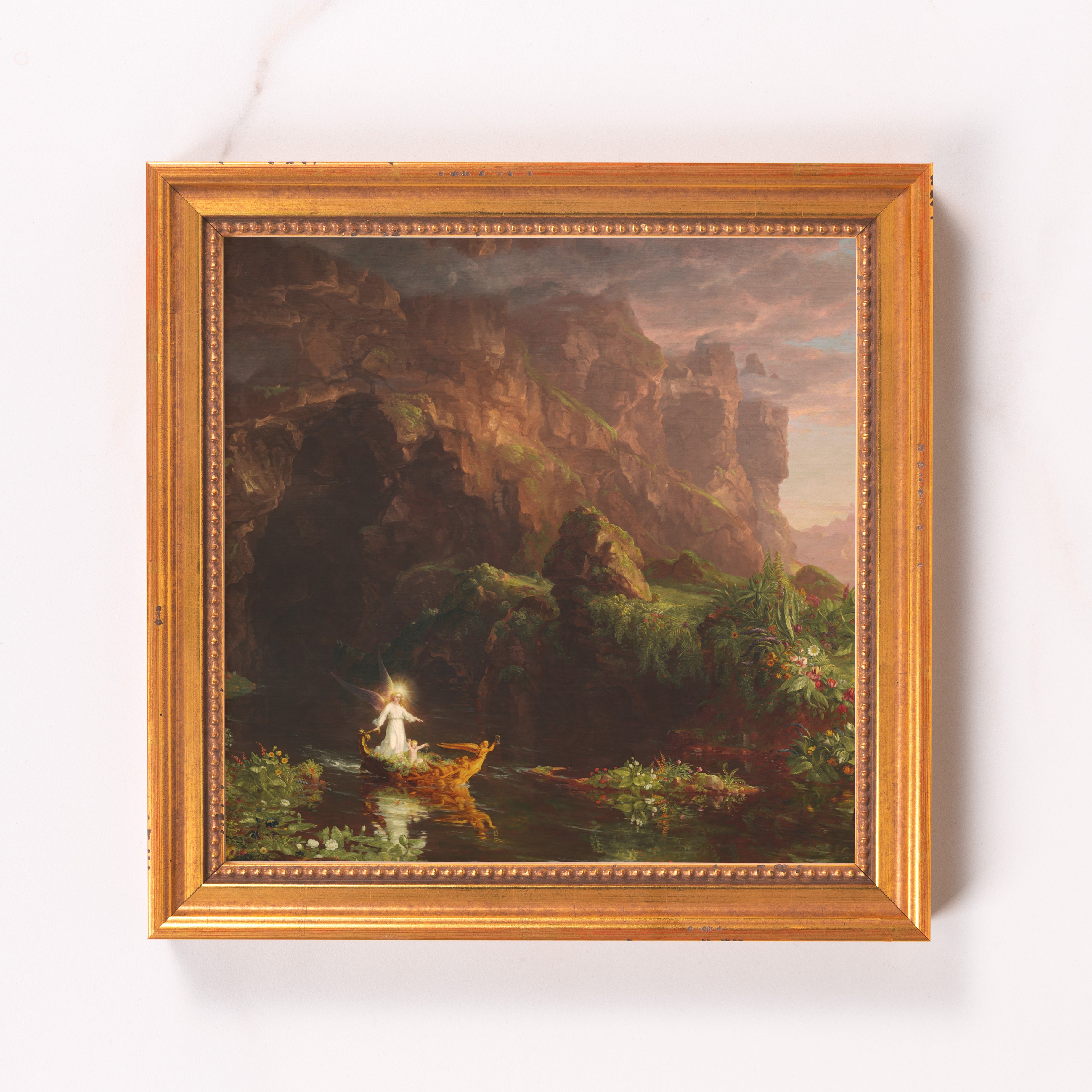 Framed art print. Angel and child on gold boat in a landscape, in ornate gold frame.
