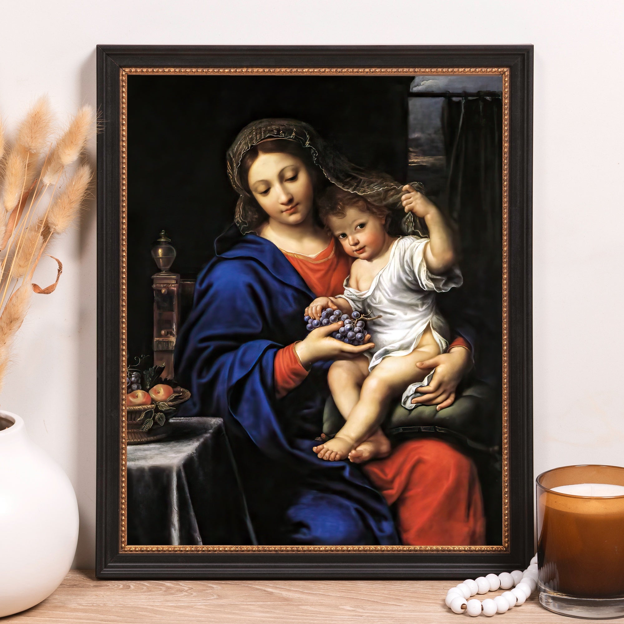 Framed, Virgin and Child art print in a black frame shows Mary with baby Jesus holding grapes in the Renaissance style.