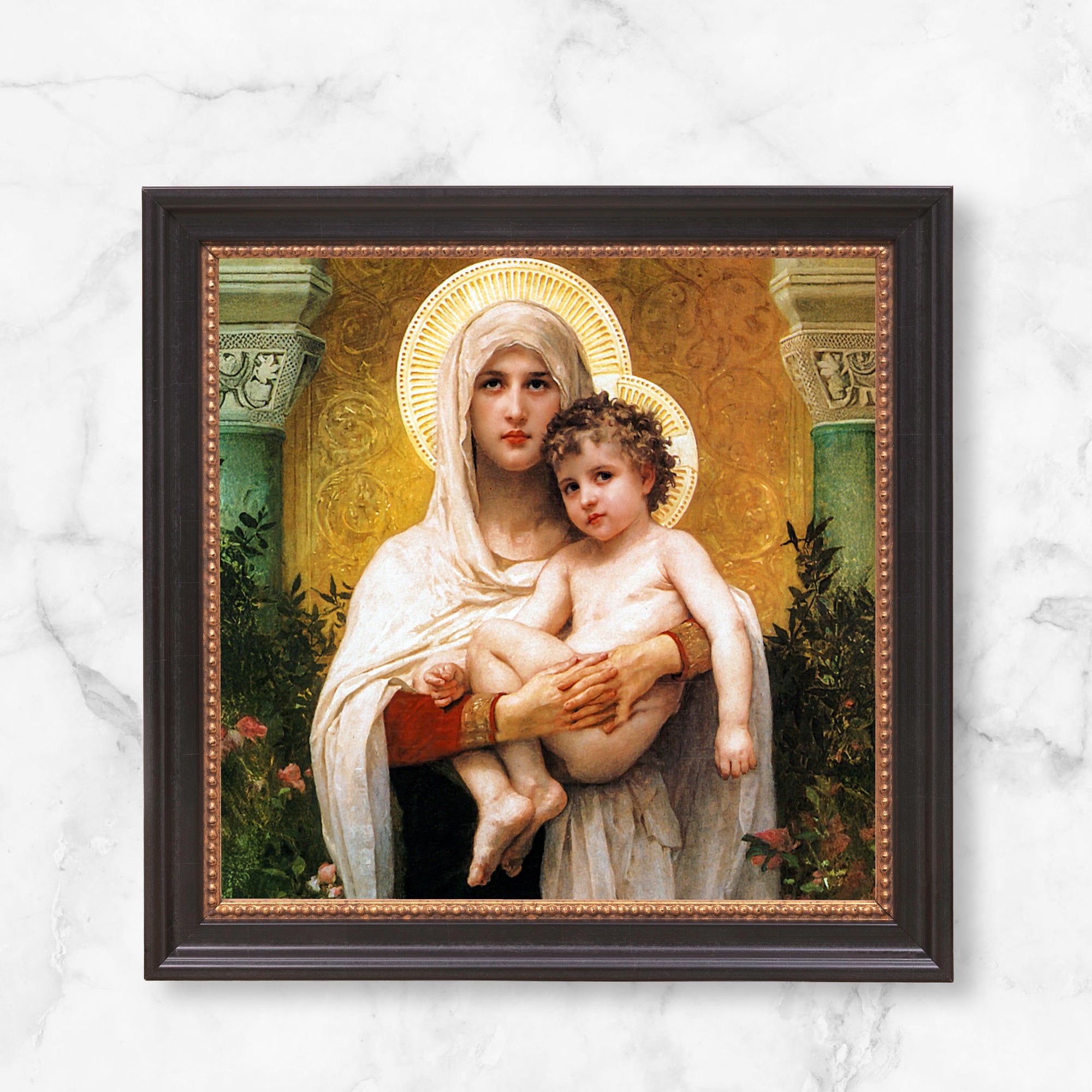 Framed art print of Virgin Mary holding child, classical style with halos, gold and green accents, and dark frame.